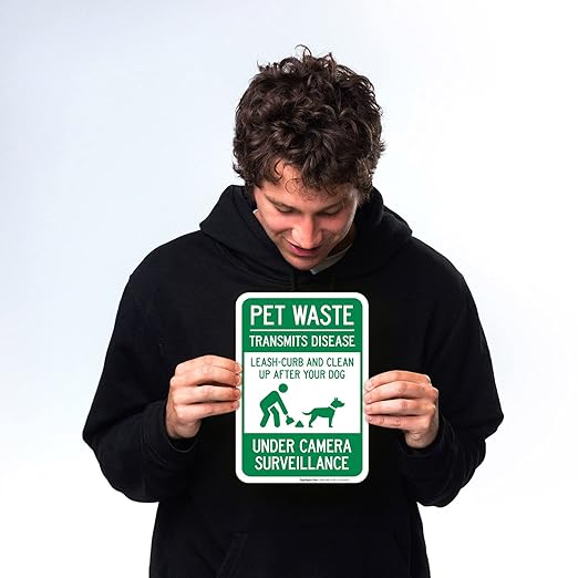 Pet Waste Leash-Curb and Clean Up After Your Dog Under Camera Surveillance Sign, (SI-63188) 10x7 Inches, 4 Mil Vinyl Decal Stickers Weather Resistant, Made in USA